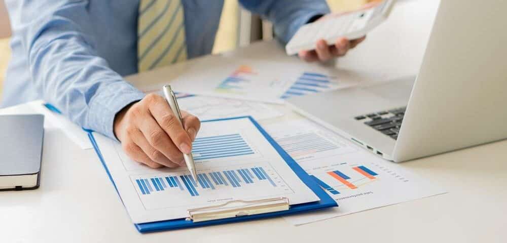 A,Businessman,In,Finance,And,Calculating,Calculators,And,Analyzing,Graphs